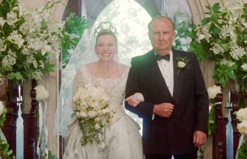 A scene from Muriel's wedding in which Muriel (Toni Collette) walks down the aisle in church on her wedding day holding on to the arm of her father Bill (Bill Hunter).