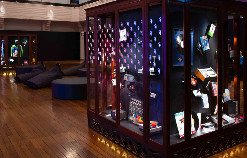 Glass cabinets of film, TV, gaming and music-related objects on display in the National Film and Sound Archive gallery spaces.