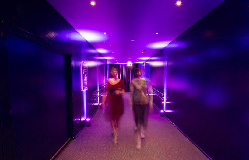 Two people walking into entrance of cinema