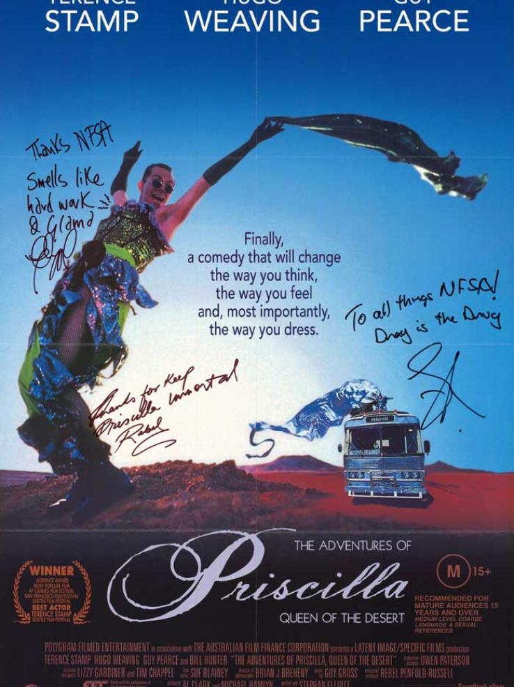 Poster from The Adventures of Priscilla, Queen of the Desert which is autographed by the crew. The poster features the iconic image of Hugo Weaving wearing the green sequin dress with the desert in the background