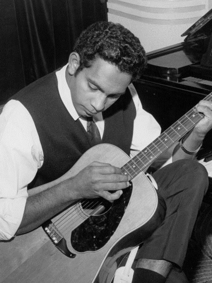 Jimmy Little playing a guitar