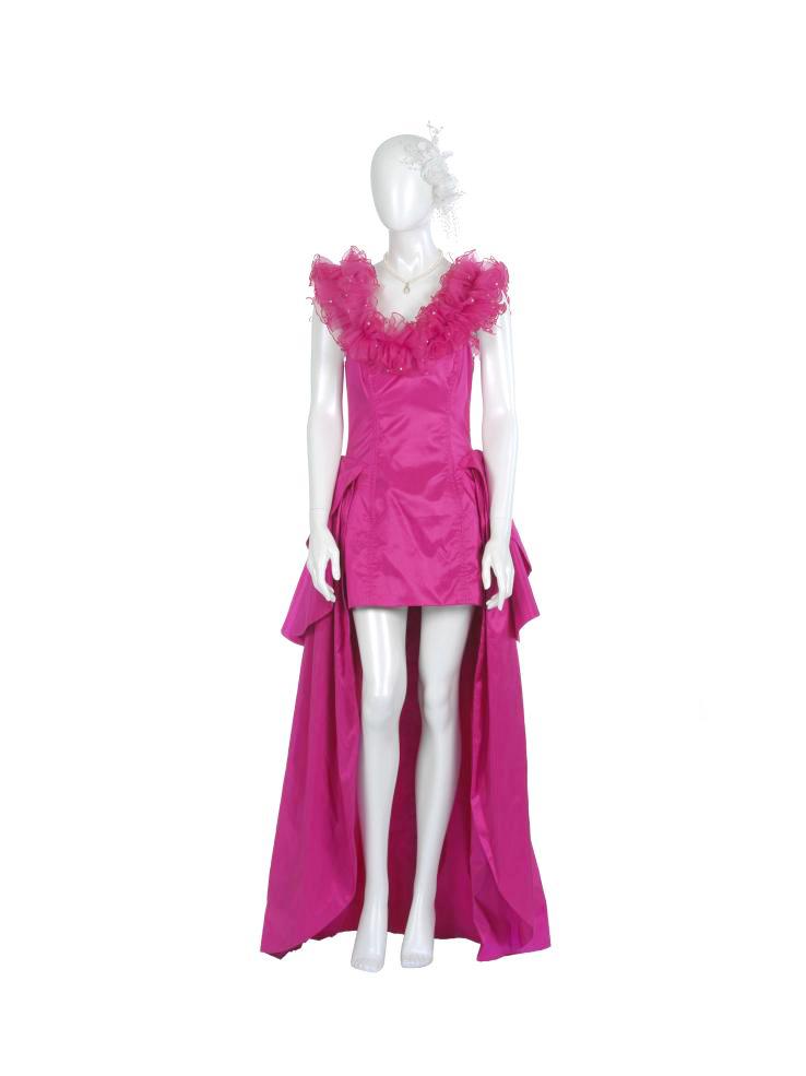 Costume from the film Muriel's Wedding - a hot pink bridesmaids dress with a short skirt, long train and ruffled neckline. 