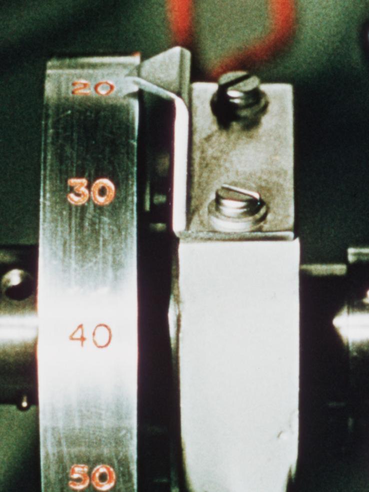 A speaking clock mechanism from the 1950s showing a metal disc etched with the numerals 20, 30, 40 and 50.