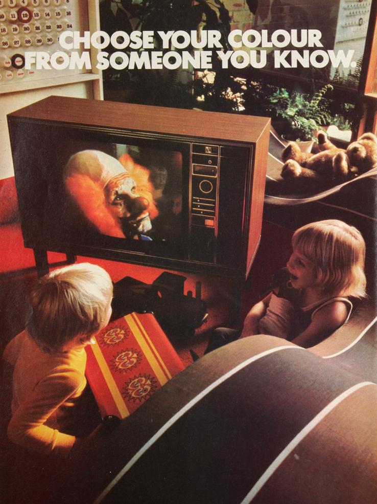 Magazine advertisement for a colour TV set featuring a sad-looking clown on the screen and two kids sitting on the floor watching the TV.