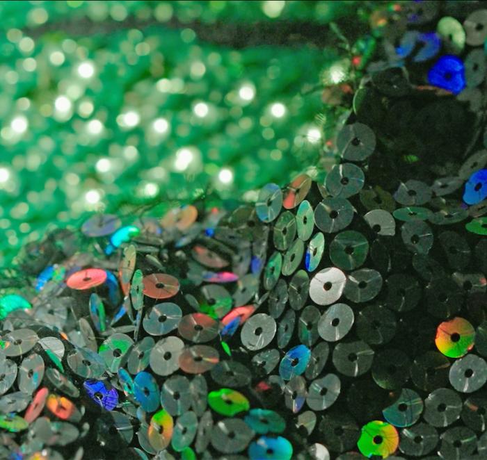 Close up of some green sequinned fabric.