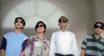 An Asian-Australian family of four, standing side by side, wearing sunglasses and staring out a window.