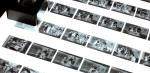Close up of a lightbox with strips of film placed on it. 