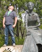 Nigel Ubrihien standing on a rock next to a sculpture