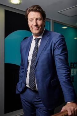 NFSA CEO Jan Muller wearing a navy blue suit and leaning on a ballustrade