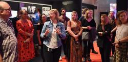 A curator gives a floor talk to a small group of attendees at the Australians & Hollywood exhibition at the NFSA
