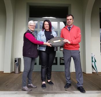 Lindsay Bell and Jan Balgowan stand either side of NFSA Curator Jillian Mackenzie handing her a film in a container.