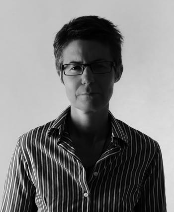 Filmmaker Julie Kalceff Head and shoulders black and white photo of filmmaker Julie Kalceff looking directly at camera.