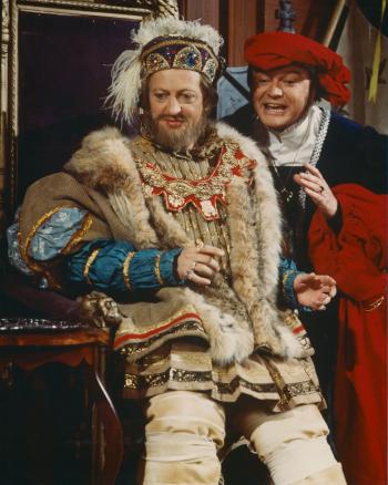Graham Kennedy sitting on the throne as Henry VIII with Bert Newton standing beside him