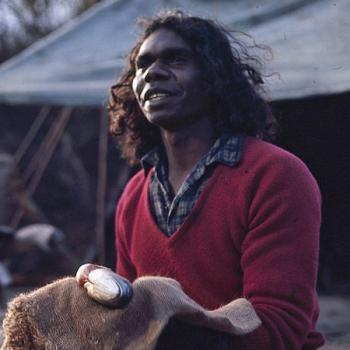 Storm Boy - David Gulpilil holding a fish David Dalaithngu as Fingerbone Bill sitting down on the outdoor set of Storm Boy holding a fish.