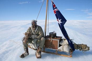 Jarvis adjusting his homemade crampons made from wooden packing cases and nails