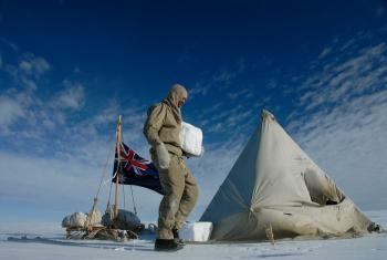 Tim Jarvis setting up camp and cutting large ice-blocks to weigh down the tent