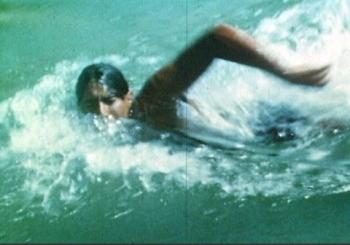 Still frame of someone swimming freestyle.