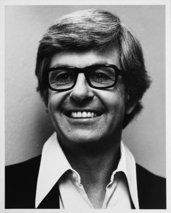 Head and shoulders publicity shot of broadcaster Bob Rogers.