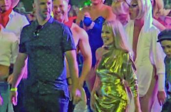Kylie at the 2019 Sydney Gay and Lesbian Mardi Gras Kylie Minogue in shimmering gold dress walks among the crowd at the Sydney Gay and Lesbian Mardi Gras in 2019