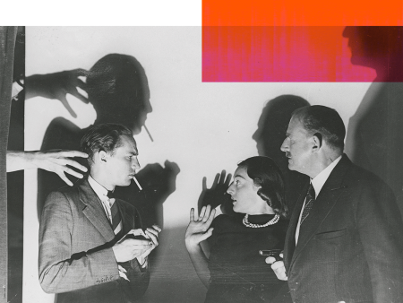 Peter Finch standing with a young woman and older man in profile. There are some menacing shadows behind them and the woman looks frightened.