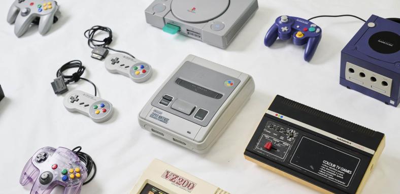Video game consoles and hardware laid out on a table