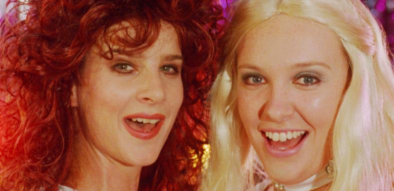 Rachel Griffiths and Toni Collette dressed as Frida and Agnetha from ABBA miming in a scene from the film Muriel's Wedding