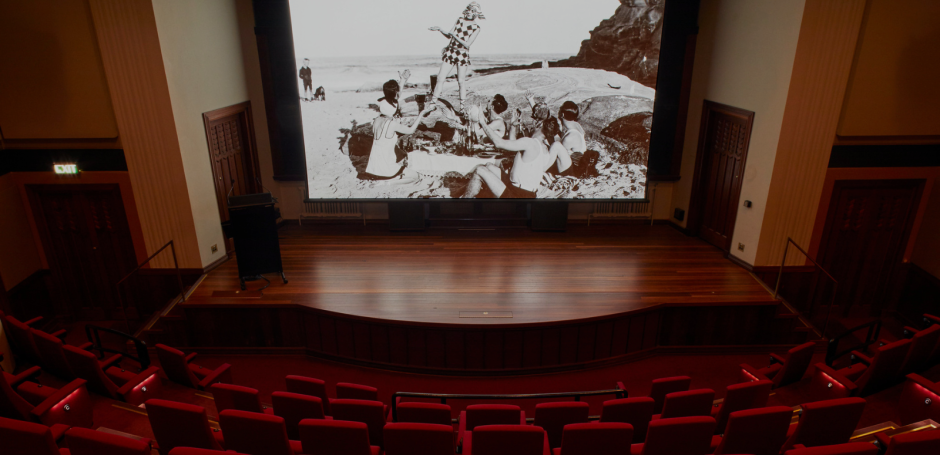 A black-and-white film showing on the big screen in the NFSA Theatrette.