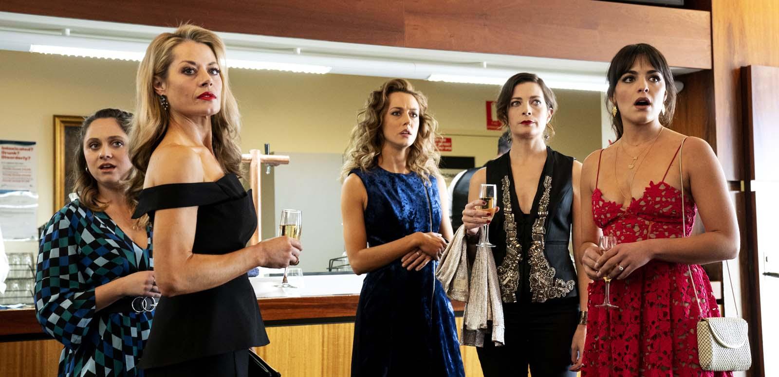 A group of five women in formal attire looking shocked A group of five women in formal attire looking shocked
