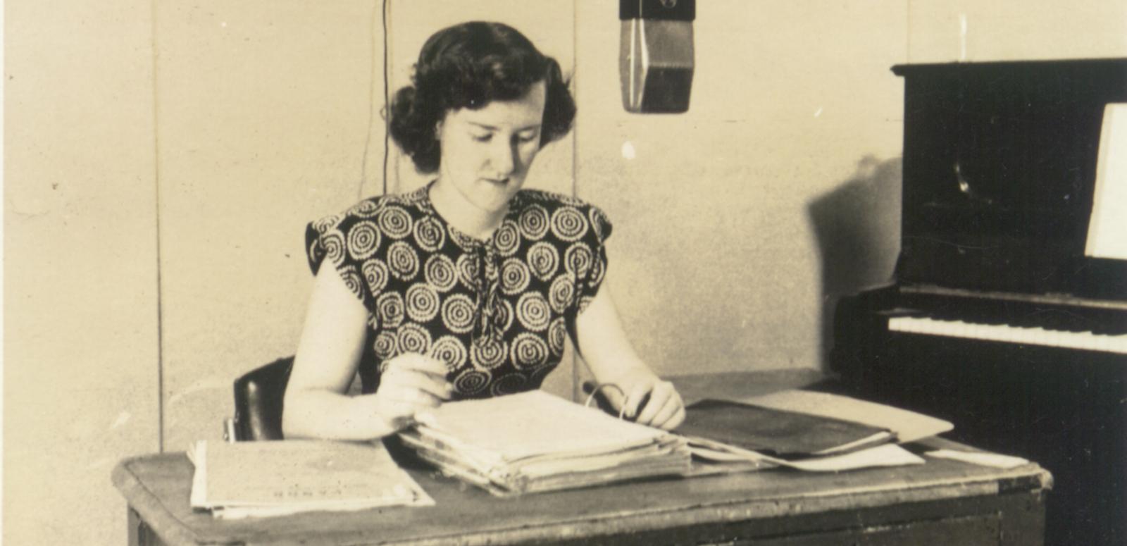 Enid Hogan behind a microphone in a radio studio