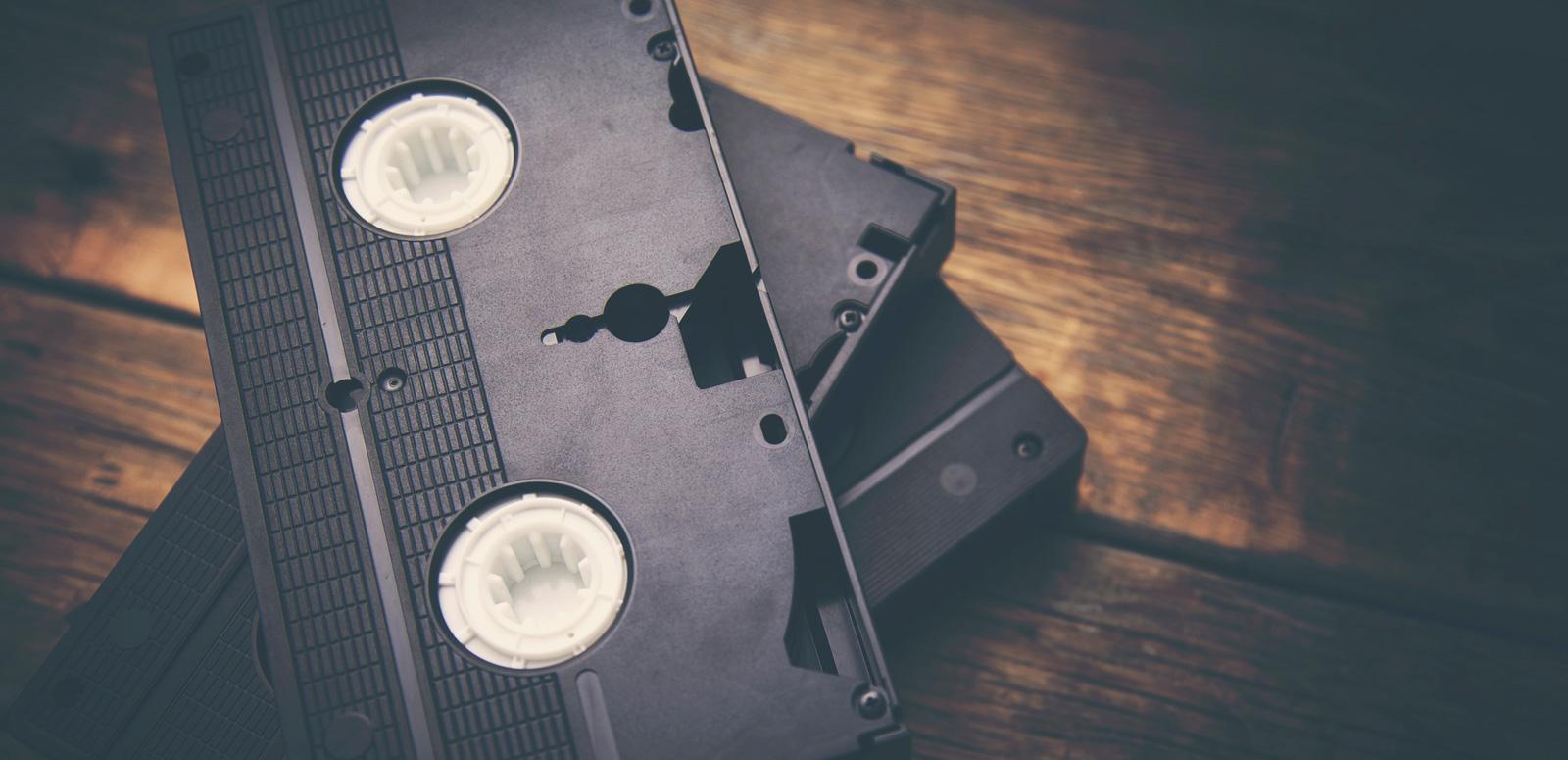 Stack of video tapes on a wooden table