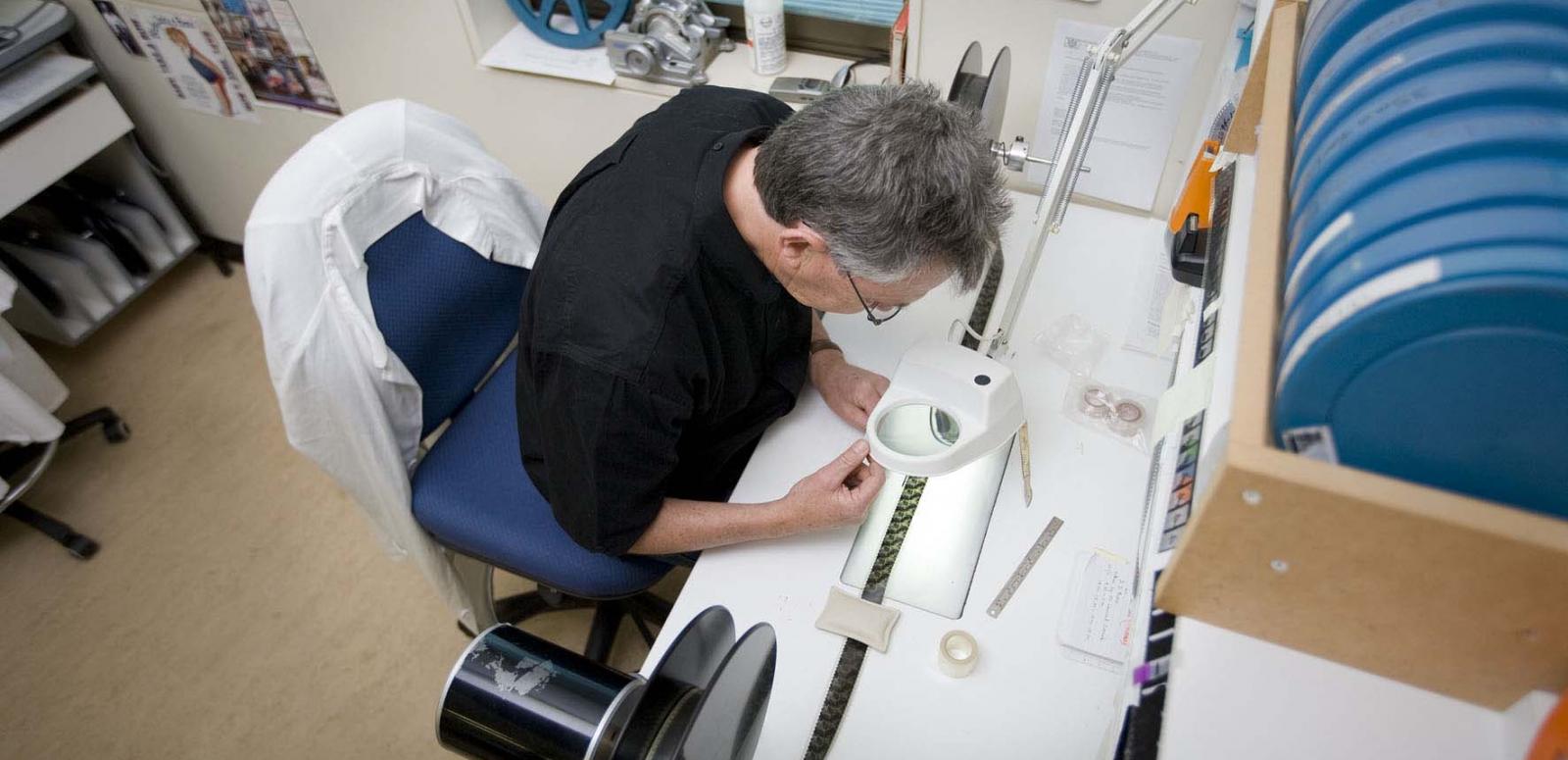 Technician handles film in a lab