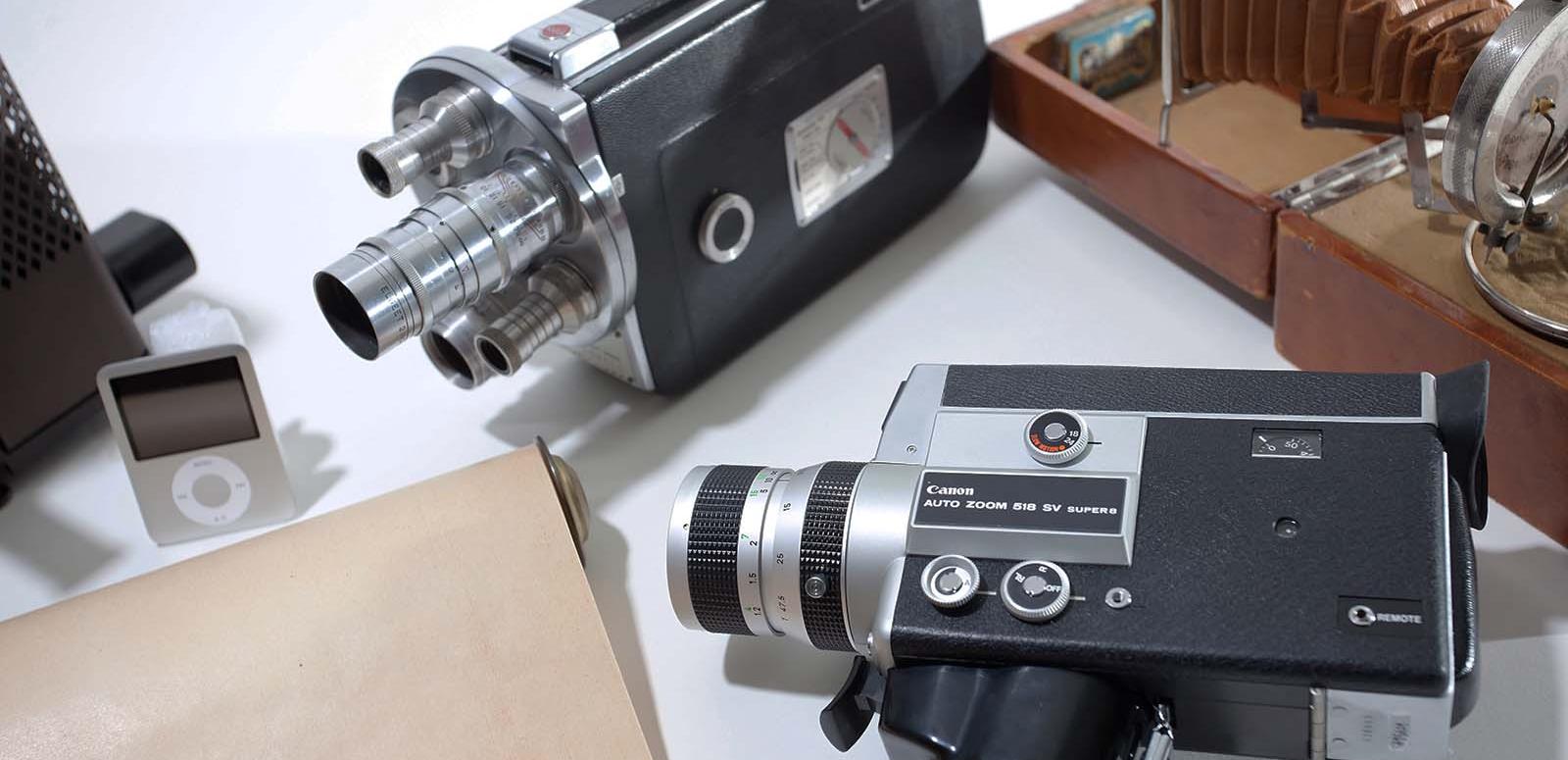 A variety of vintage camera and an ipod are displayed