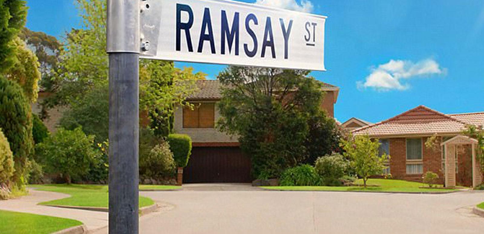 A few houses in a cul-de-sac with a street sign in the foreground that says Ramsay St