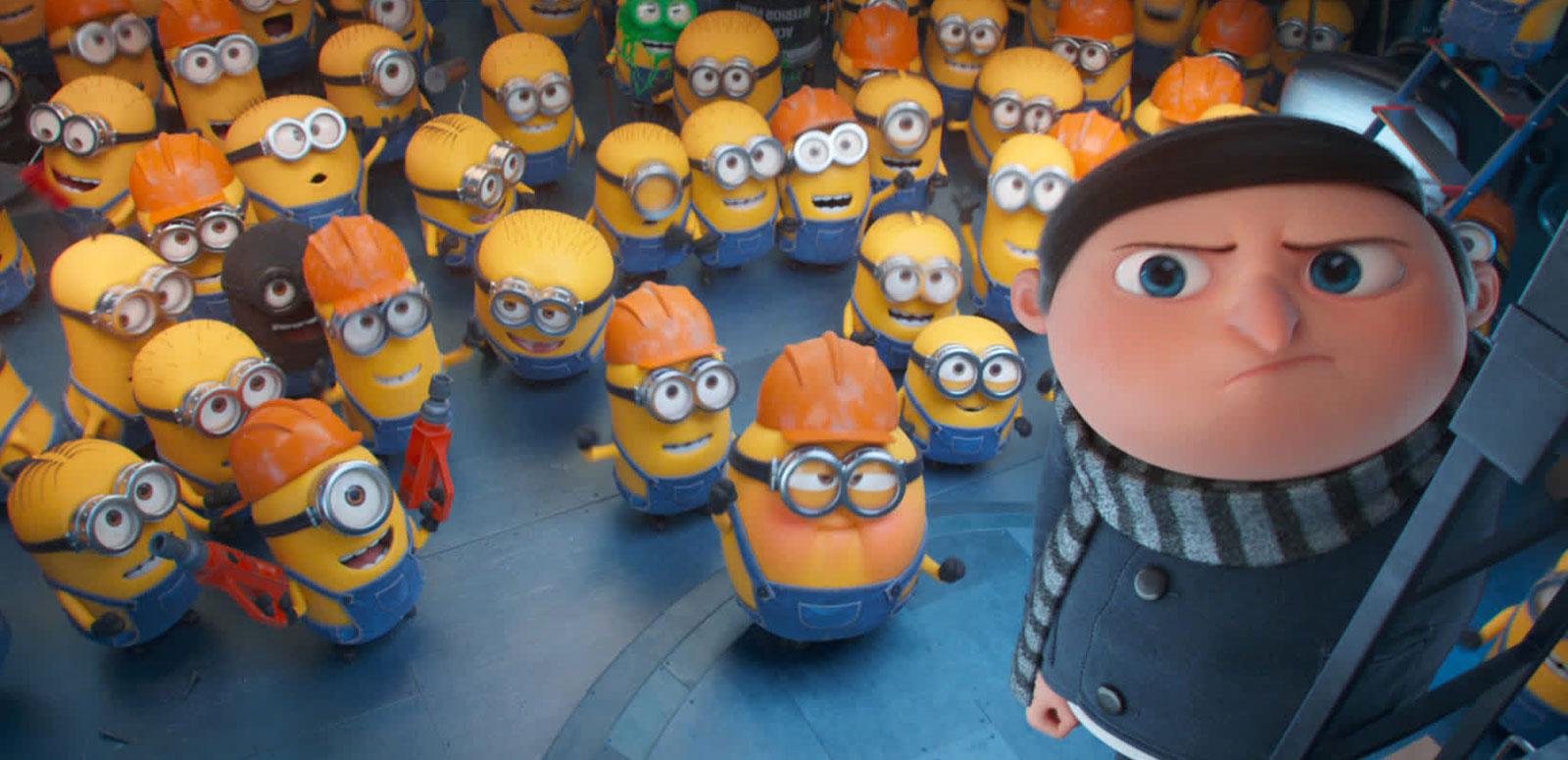 Animation still from a film showing a young boy up a ladder and a group of yellow 'minion' characters on the ground below him