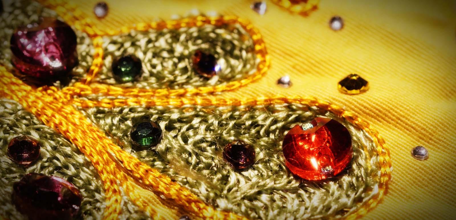 Detail of a yellow shirt worn by a country singer in the film ELVIS, studded with sparkling jewels
