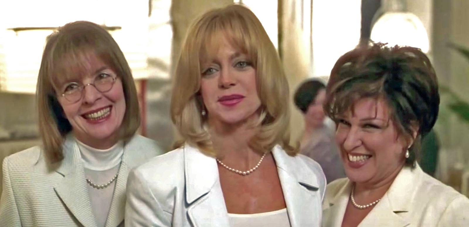 Head and shoulders shot of three women wearing white blazers (Diane Keaton, Goldie Hawn and Bette Midler) smiling in a scene from the film The First Wives Club.