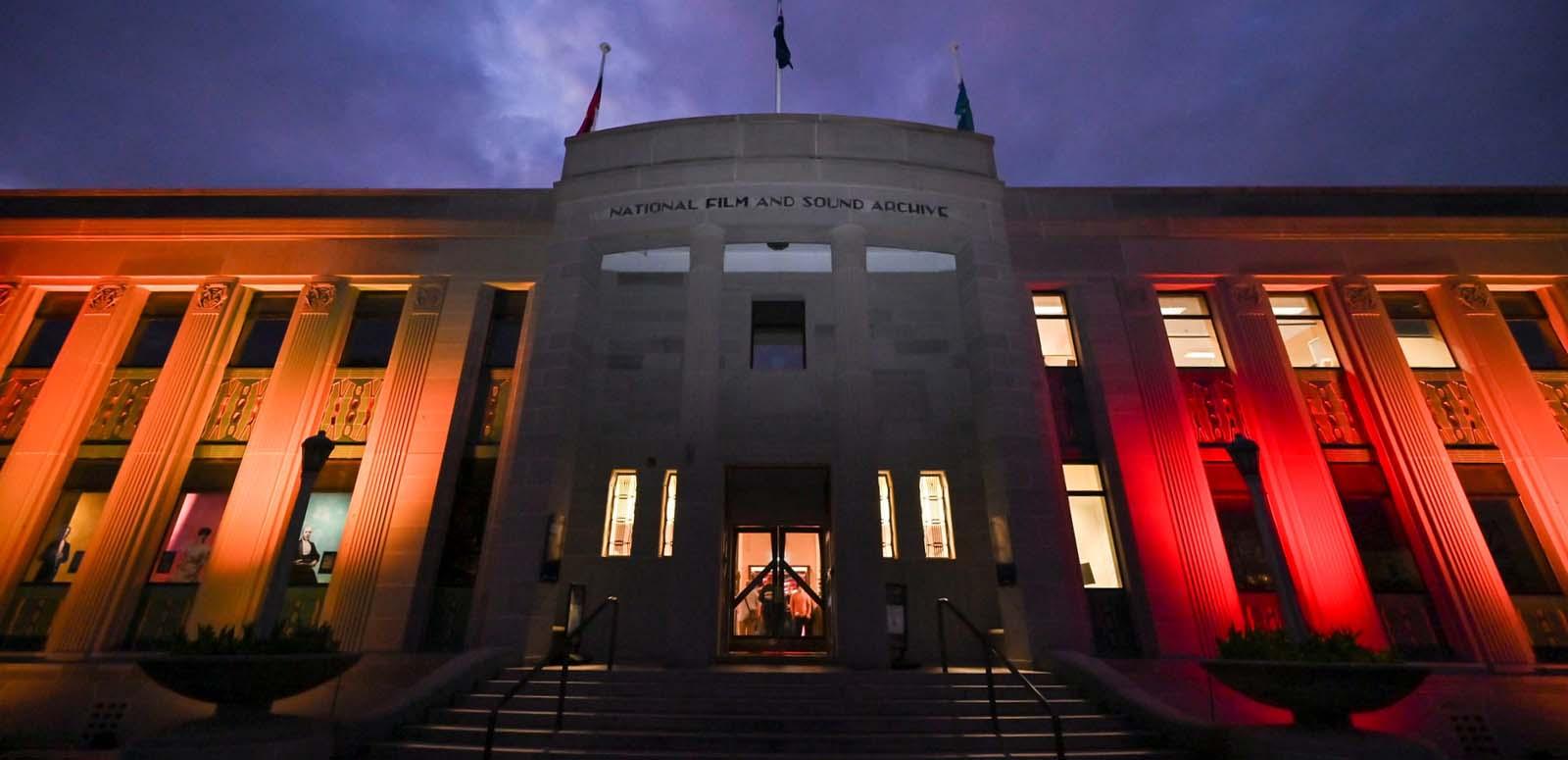The lighted exterior of the NFSA building in Canberra at night