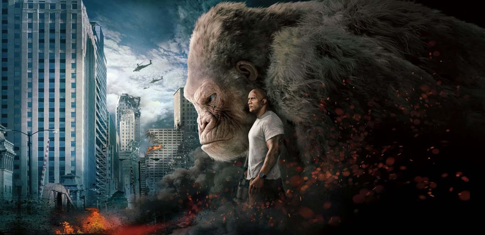 Detail from the poster for the movie Rampage. Dwayne Johnson stands next to an oversized gorilla while city buildings explode and helicopters look down on the carnage.