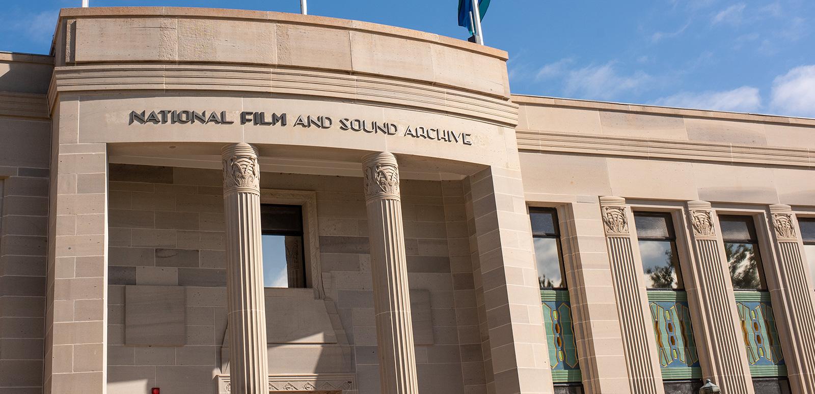 Front facade of an art deco style building with columns at the front and a sign saying National Film and Sound Archive.