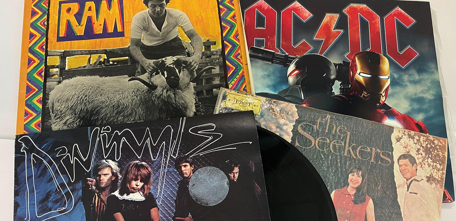 Four record covers laid out on a table.