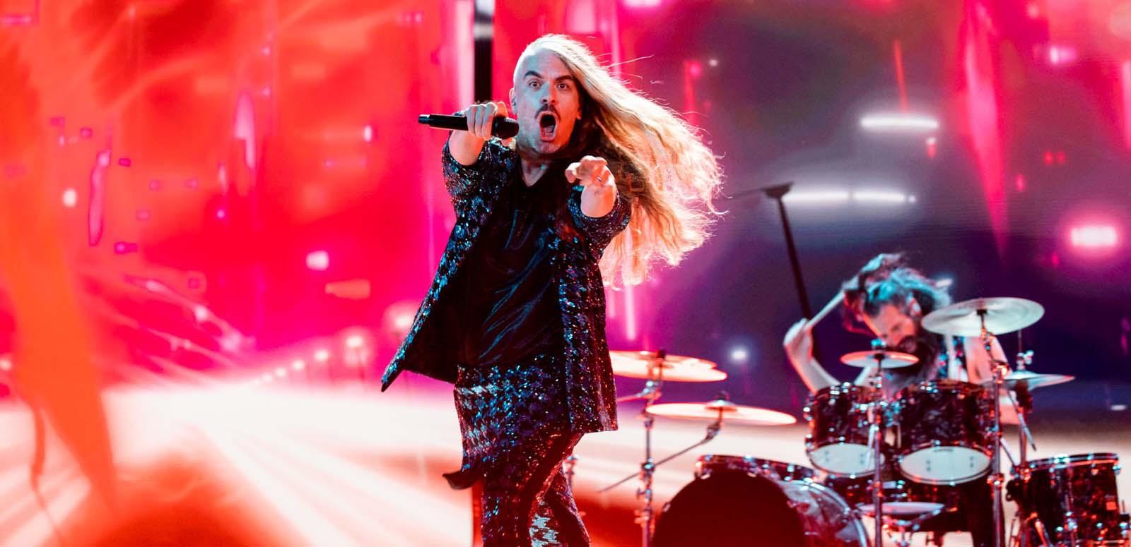 Daniel Estrin, lead singer of the rock band Voyager, points at the camera while rehearsing on the Eurovision Song Contest stage with drummer Ashley Doodkorte