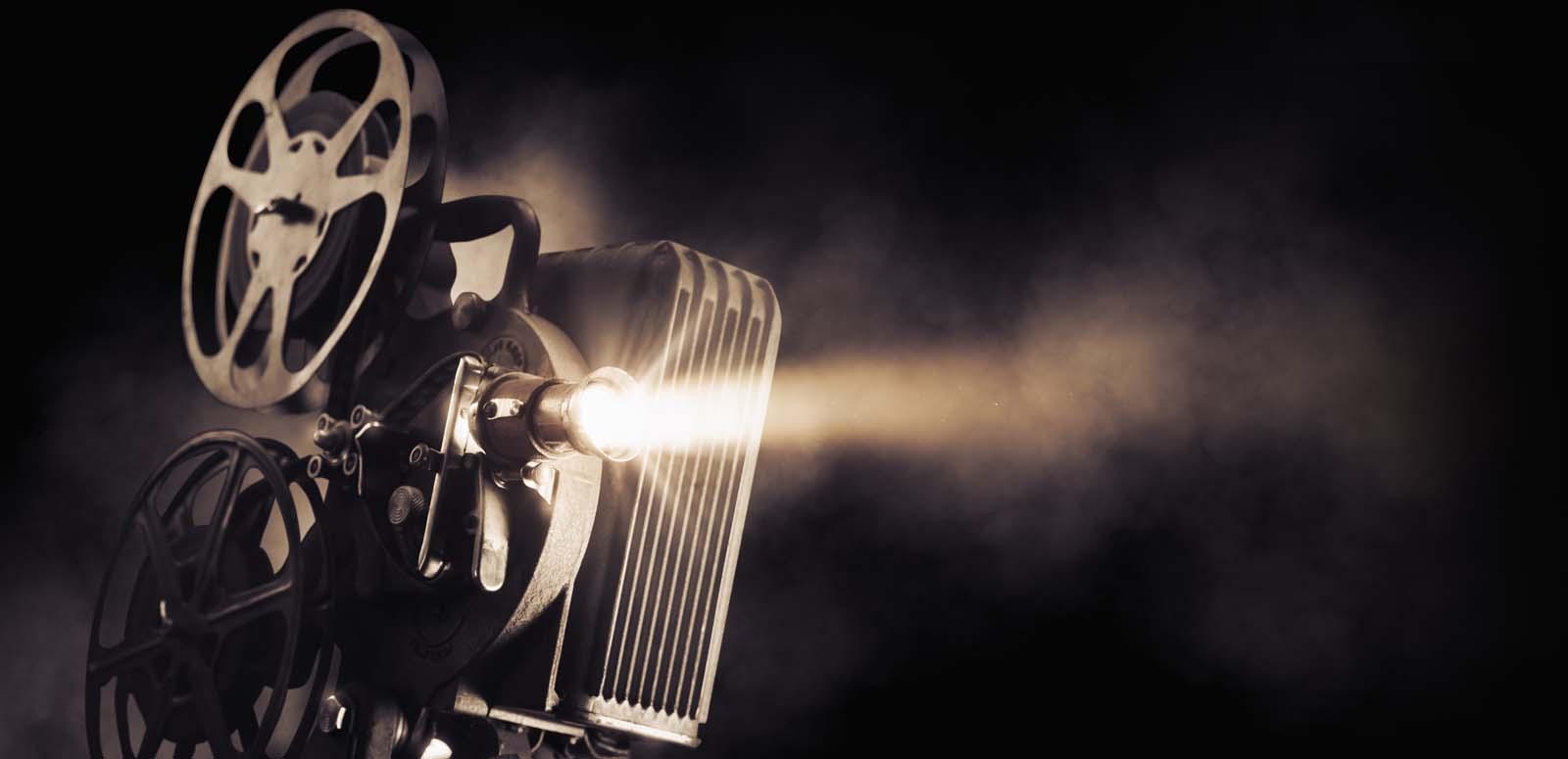 A vintage film projector running a reel of film