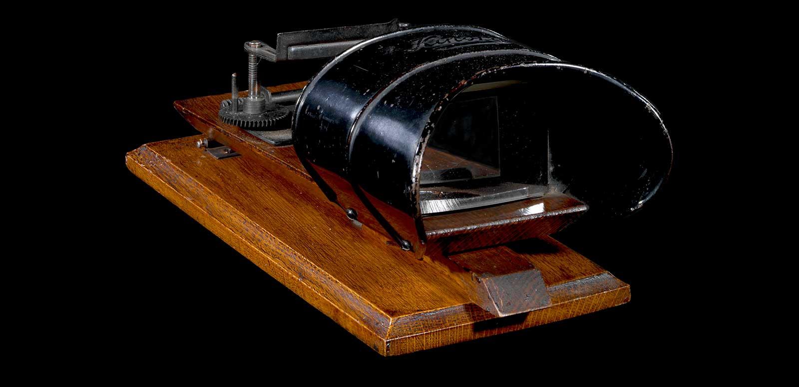 A kinora flipper viewer on a wooden platform