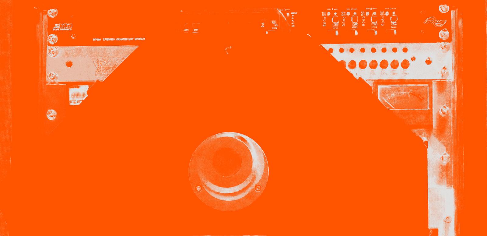 A close-up image of audio equipment that has been tinted orange