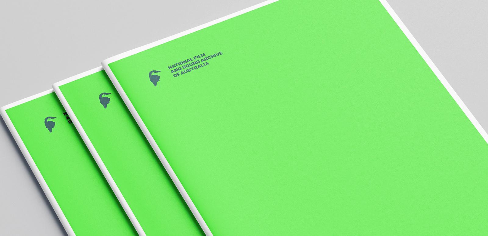 Documents featuring a black National Film and Sound Archive kookaburra logo on a lime green cover