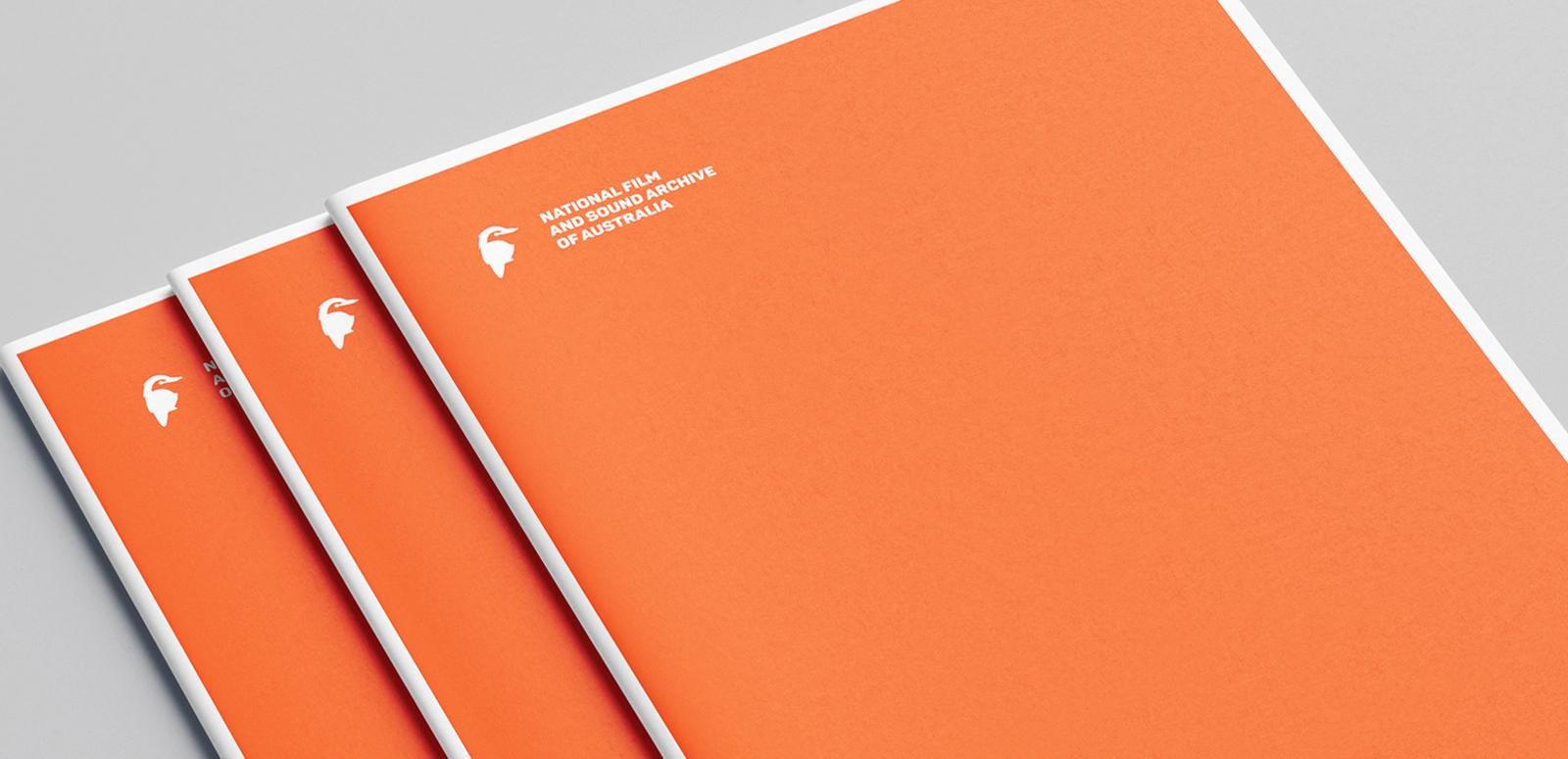 Documents featuring a white National Film and Sound Archive kookaburra logo on an orange cover
