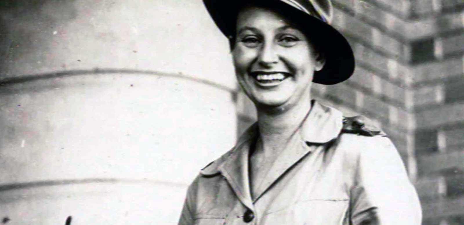 Head and shoulders image of a woman in an army uniform smiling