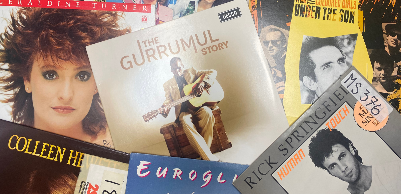 A selection of album covers featuring Australian recording artists including Gurrumul, Rick Springfield, Eurogliders, Colleen Hewett, Geraldine Turner and Paul Kelly