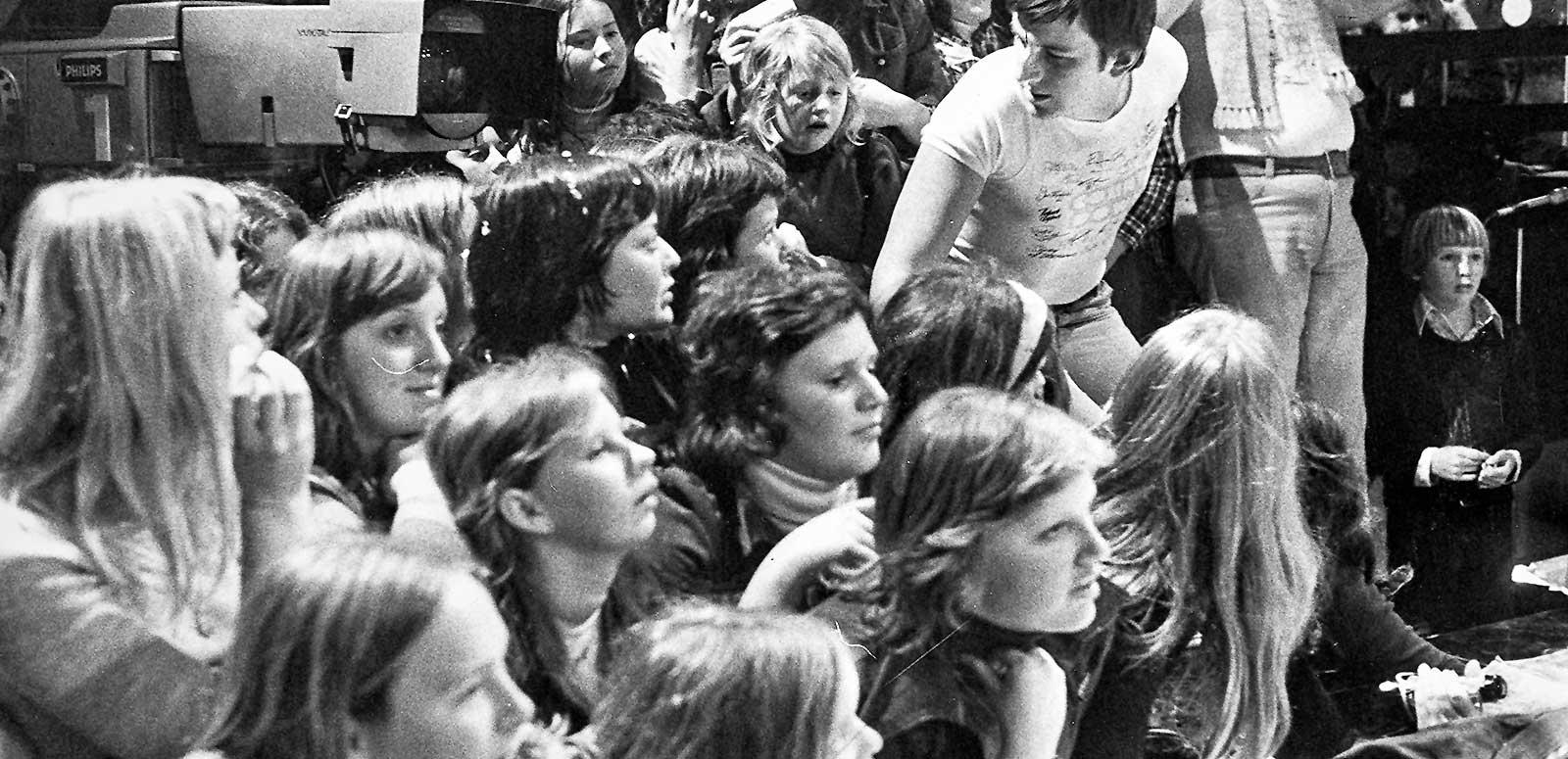 A group of teenagers in the studio audience during the taping of a tv show