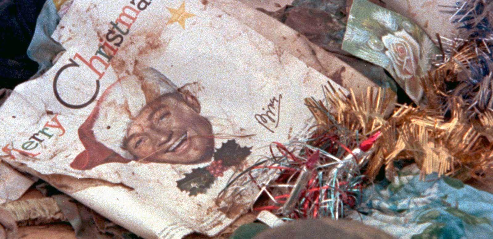 A crumpled record cover of a Christmas album sitting on the ground among wreckage following the devastation of Darwin by Cyclone Tracy in 1974.